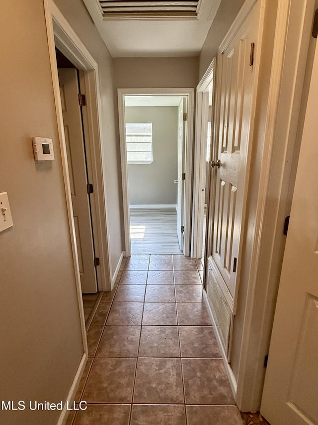 108 Mount Bass, Long Beach, MS 39560 - corridor with dark tile patterned flooring and baseboards