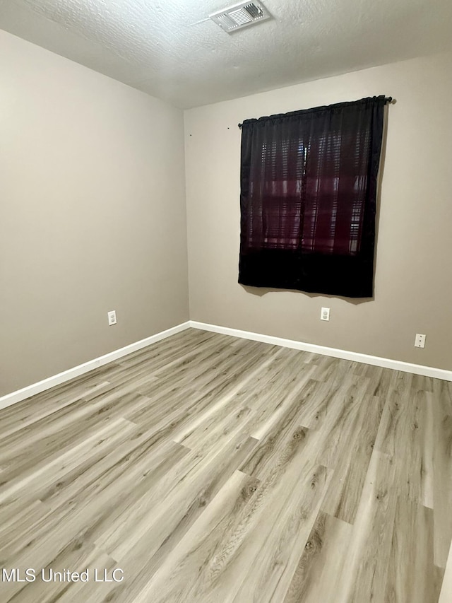108 Mount Bass, Long Beach, MS 39560 - unfurnished room with wood finished floors, baseboards, and a textured ceiling