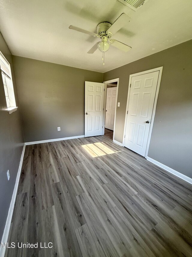 108 Mount Bass, Long Beach, MS 39560 - unfurnished bedroom with baseboards, wood finished floors, and a ceiling fan