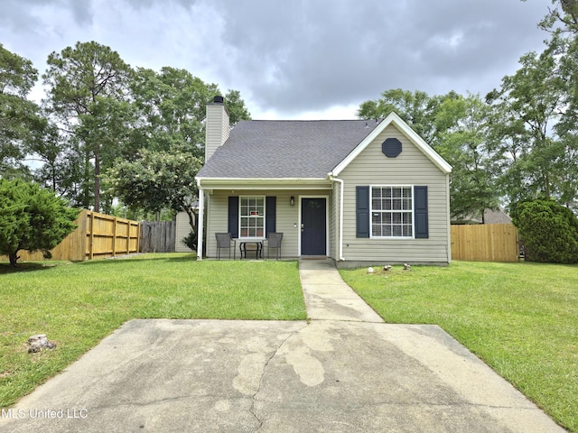 bungalow featuring a chimney, a front yard, a porch, and fence