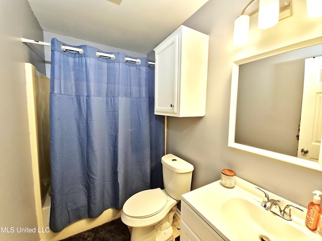 full bath featuring toilet, shower / tub combo with curtain, and vanity