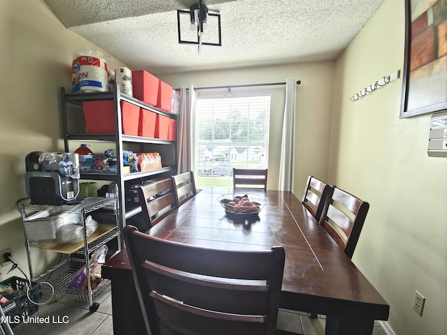 tiled dining area with a textured ceiling