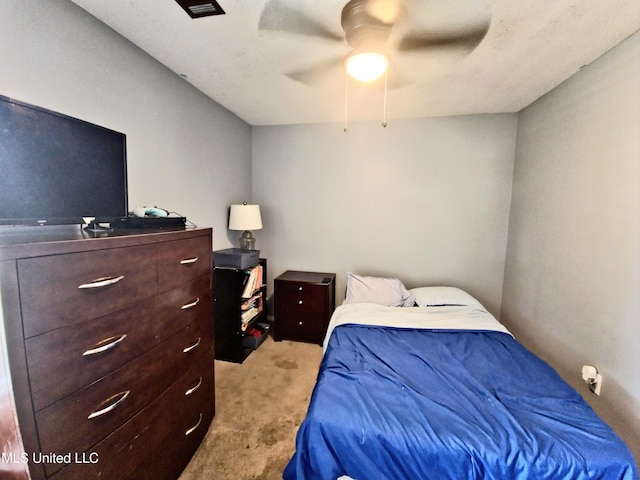 bedroom with a ceiling fan and carpet flooring