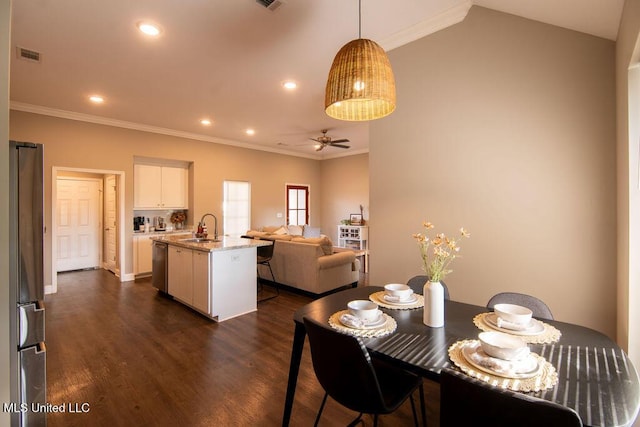 dining room featuring visible vents, a ceiling fan, dark wood-type flooring, and crown molding