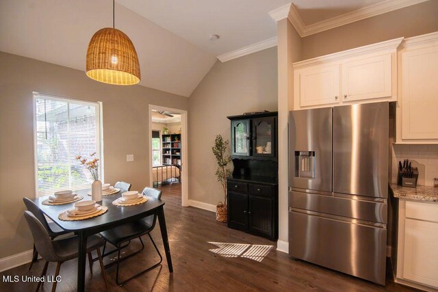 dining room featuring baseboards, crown molding, dark wood-type flooring, and lofted ceiling