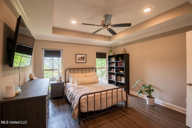 bedroom featuring ornamental molding, baseboards, dark wood-style floors, recessed lighting, and a tray ceiling