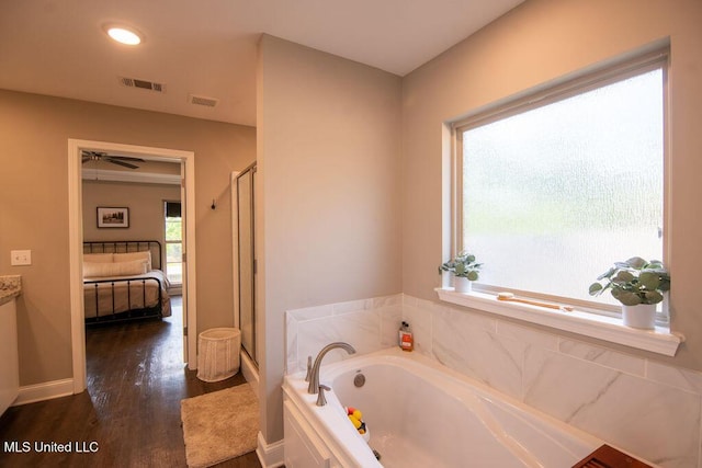 ensuite bathroom with visible vents, a garden tub, wood finished floors, ensuite bathroom, and a shower stall