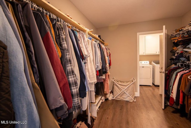 spacious closet with wood finished floors and washer and dryer