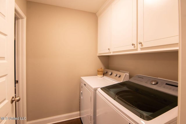 washroom featuring cabinet space and washer and dryer