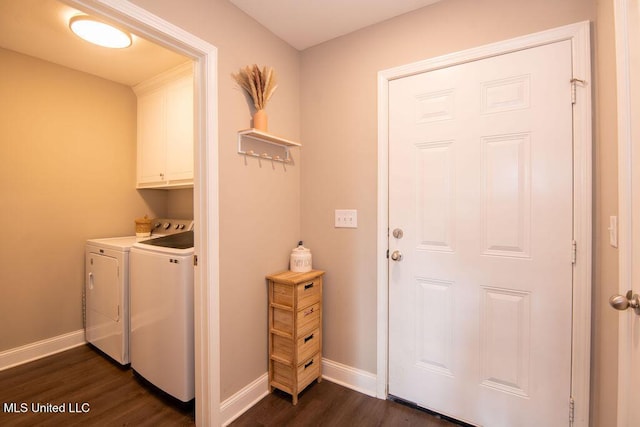 laundry area featuring cabinet space, baseboards, dark wood finished floors, and washer and clothes dryer