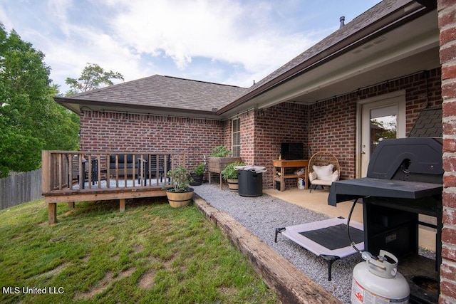 view of patio featuring a wooden deck and fence