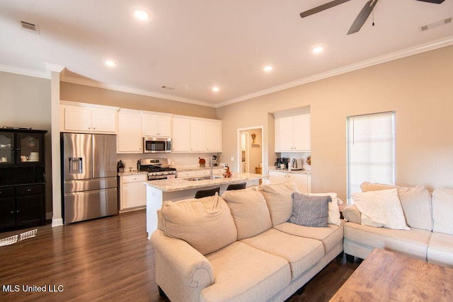 living area with visible vents, ornamental molding, dark wood-style flooring, and ceiling fan