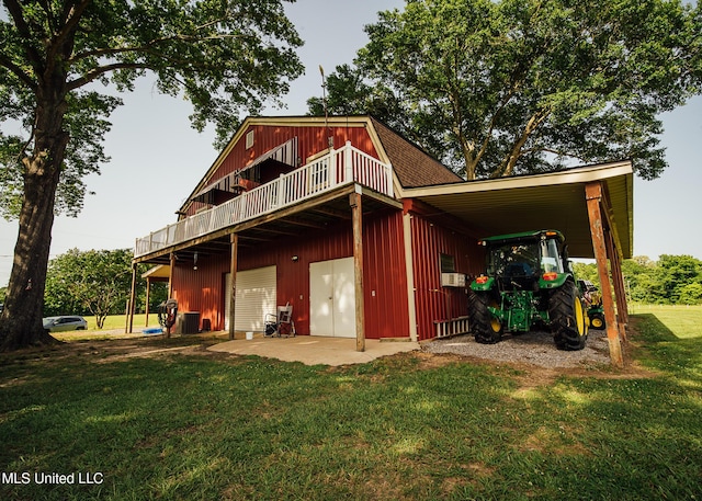 103 Hidden Lake Rd, Flora, MS 39071 - rear view of property featuring a lawn, a wooden deck, cooling unit, a gambrel roof, and a detached garage