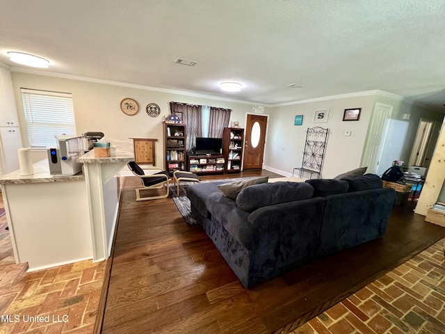 living area featuring crown molding, brick flooring, and baseboards