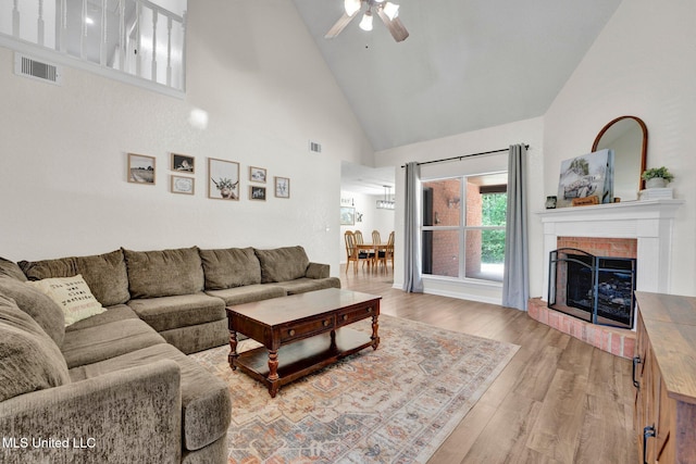 6177 W Sandbourne, Olive Branch, MS 38654 - living room featuring ceiling fan, a brick fireplace, high vaulted ceiling, light wood-type flooring, and visible vents