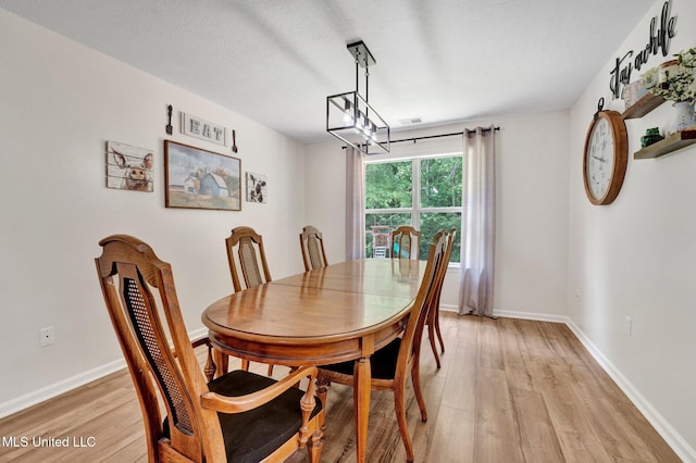 6177 W Sandbourne, Olive Branch, MS 38654 - dining space featuring a textured ceiling, baseboards, a chandelier, and light wood-type flooring