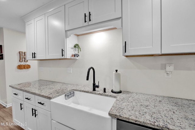 6177 W Sandbourne, Olive Branch, MS 38654 - kitchen with white cabinets, light stone counters, a sink, and light wood-style floors