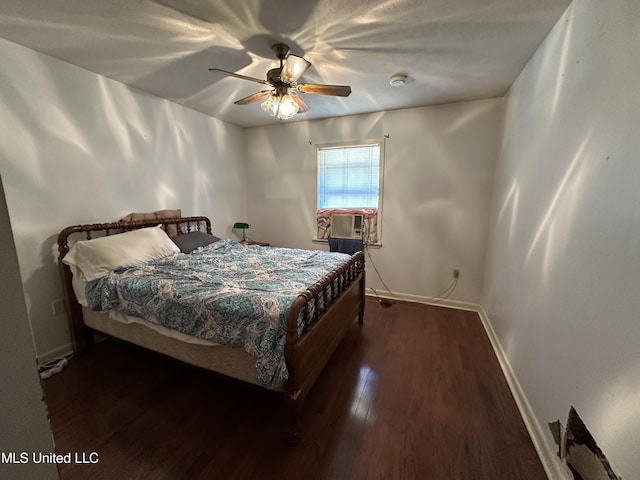 bedroom featuring cooling unit, ceiling fan, and dark wood-type flooring