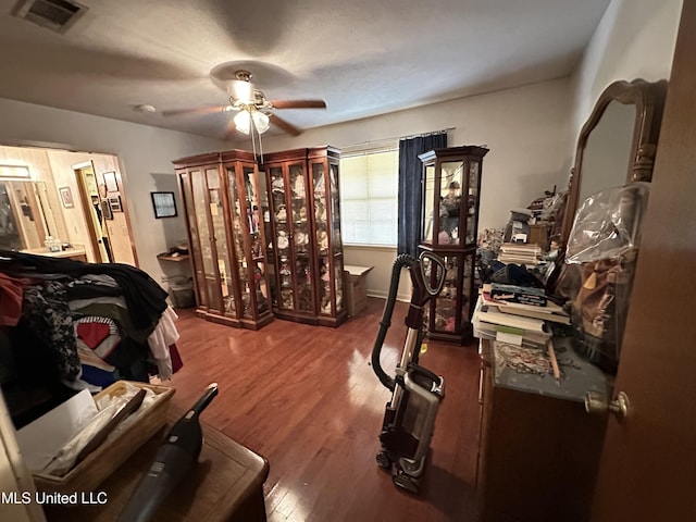 interior space with ceiling fan and dark wood-type flooring