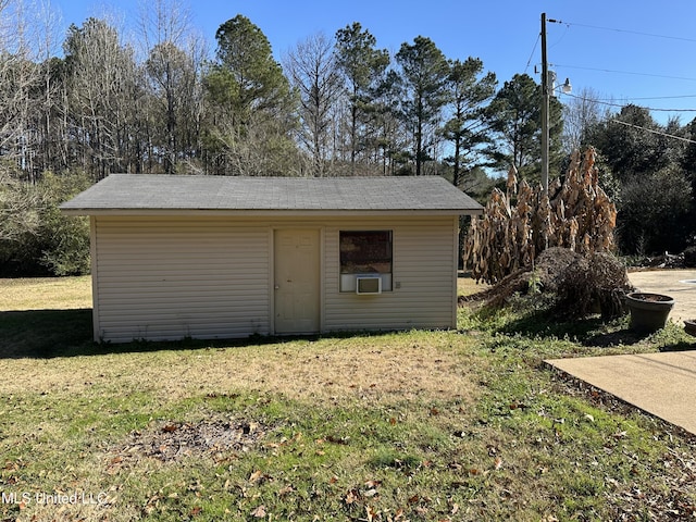 view of outbuilding with a yard and cooling unit