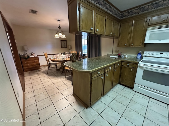 kitchen with a notable chandelier, white appliances, kitchen peninsula, and light tile patterned floors