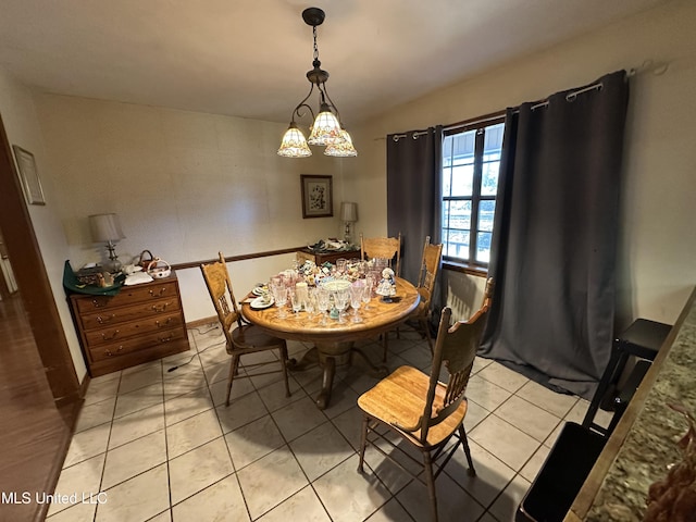 dining room featuring light tile patterned floors and an inviting chandelier