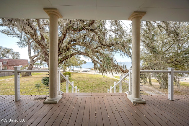 wooden terrace with a lawn