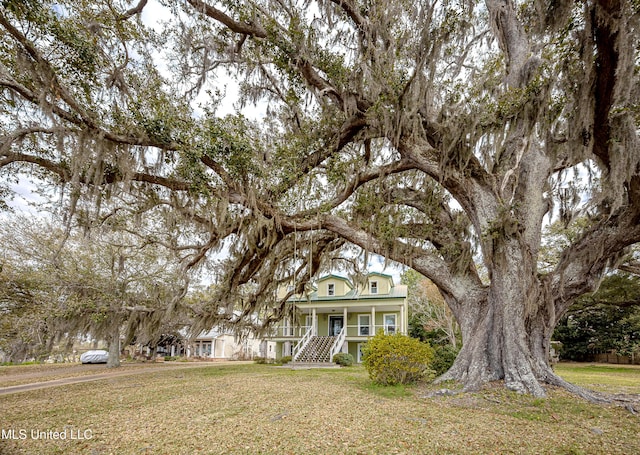 view of front of home with a porch and a front lawn