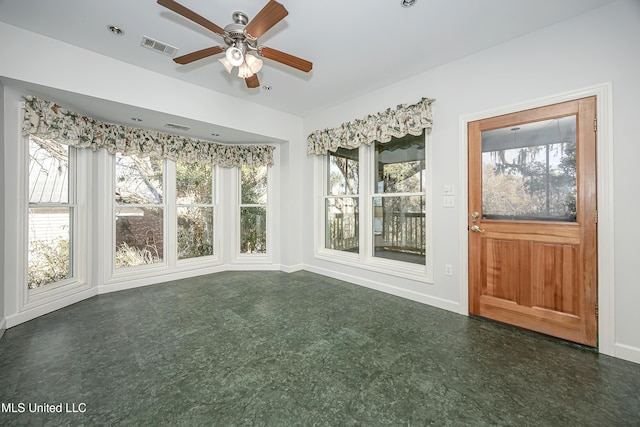 unfurnished sunroom featuring visible vents and a ceiling fan