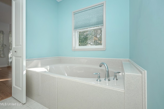 full bathroom featuring a bath and tile patterned floors