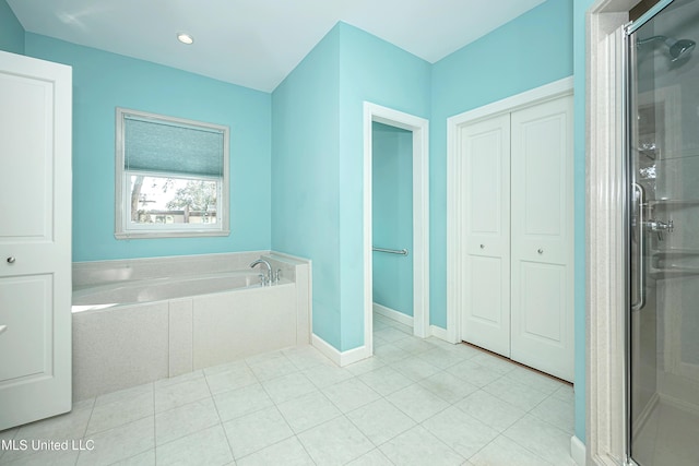 full bathroom featuring a stall shower, baseboards, a garden tub, and tile patterned floors