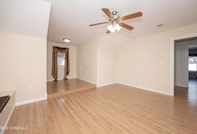 unfurnished room featuring light wood-type flooring, a healthy amount of sunlight, baseboards, and visible vents