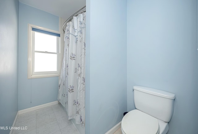 bathroom with curtained shower, baseboards, toilet, and tile patterned floors