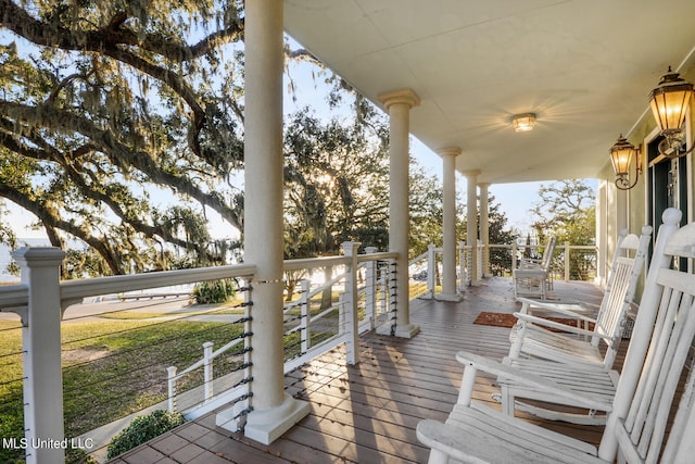 deck with covered porch and ceiling fan