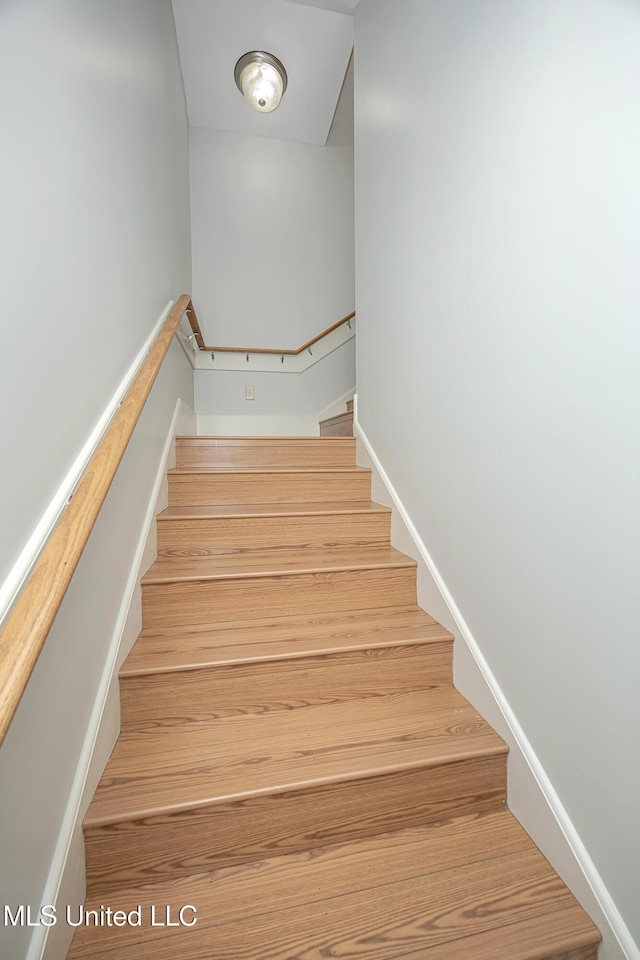 stairway featuring baseboards