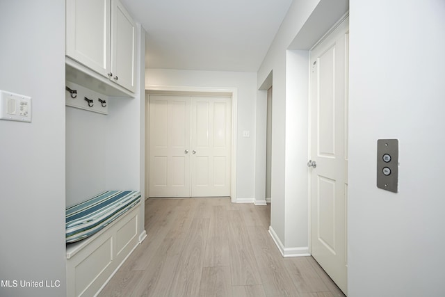 mudroom featuring light wood-style floors and baseboards