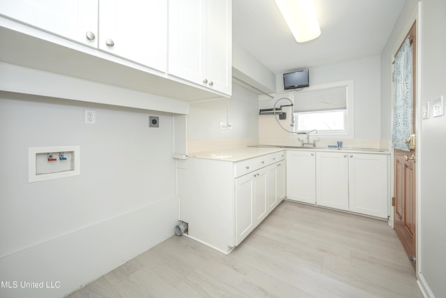 washroom with light wood-type flooring, cabinet space, washer hookup, and hookup for an electric dryer