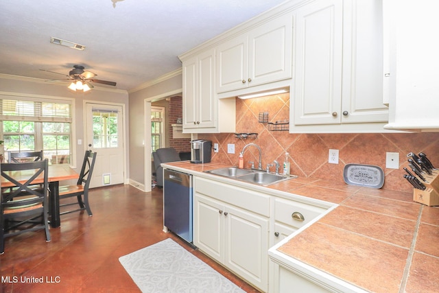 404 Briars Bnd, Brandon, MS 39042 - kitchen featuring stainless steel dishwasher, ceiling fan, ornamental molding, tasteful backsplash, and tile countertops