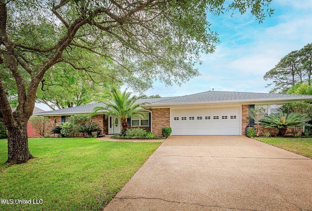 ranch-style house featuring a front lawn and a garage