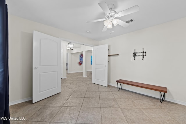 unfurnished room with light tile patterned floors and ceiling fan