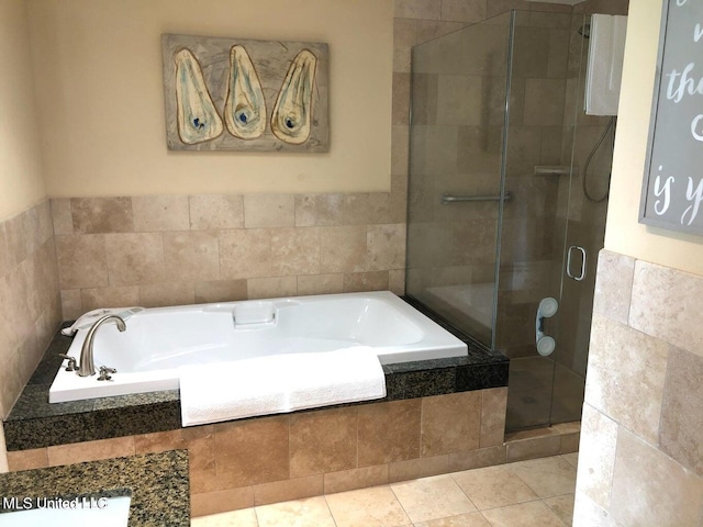 bathroom featuring a bath and a shower stall