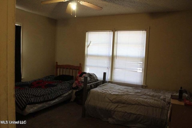 bedroom featuring a textured ceiling and ceiling fan