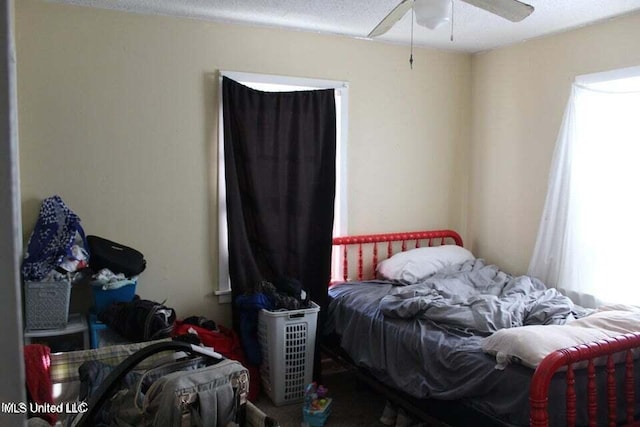 bedroom with a textured ceiling and ceiling fan