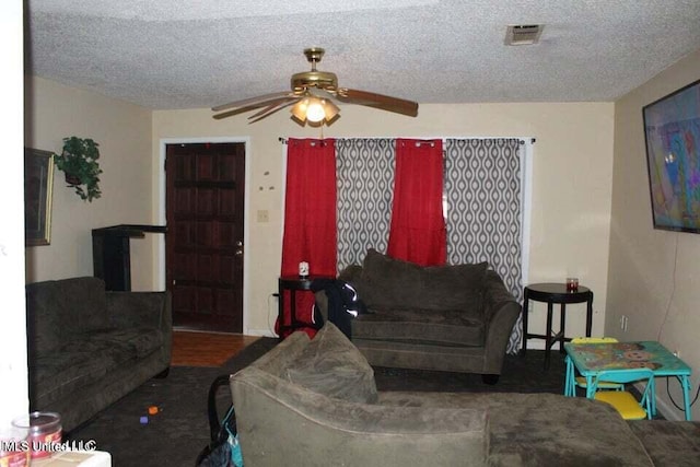 living room featuring a textured ceiling and ceiling fan