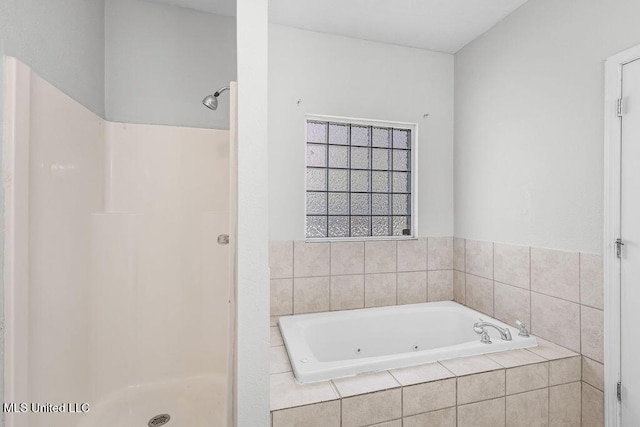 bathroom featuring shower with separate bathtub