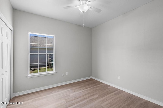 empty room featuring light wood-type flooring and ceiling fan