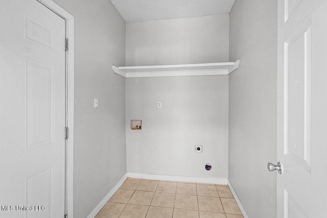 laundry area with hookup for an electric dryer, light tile patterned flooring, and hookup for a washing machine