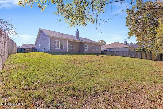 rear view of house featuring a lawn