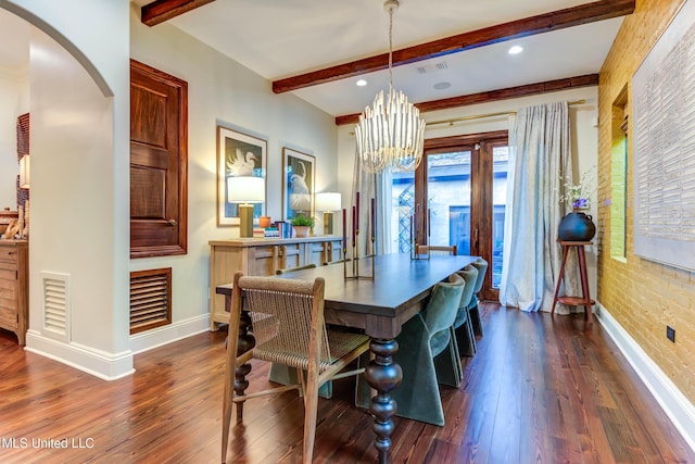 dining space with arched walkways, visible vents, and dark wood-style floors