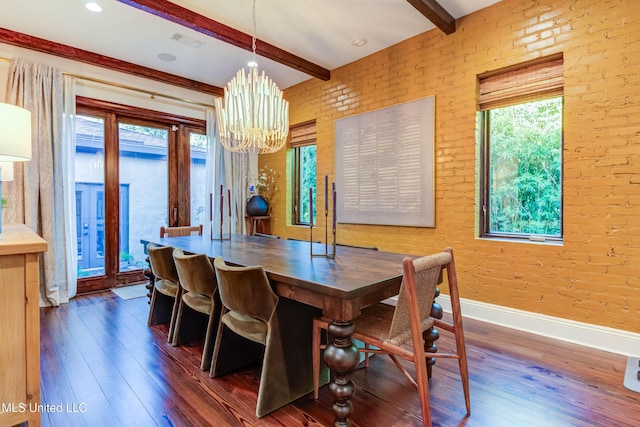 dining space featuring beamed ceiling, a notable chandelier, wood finished floors, and brick wall